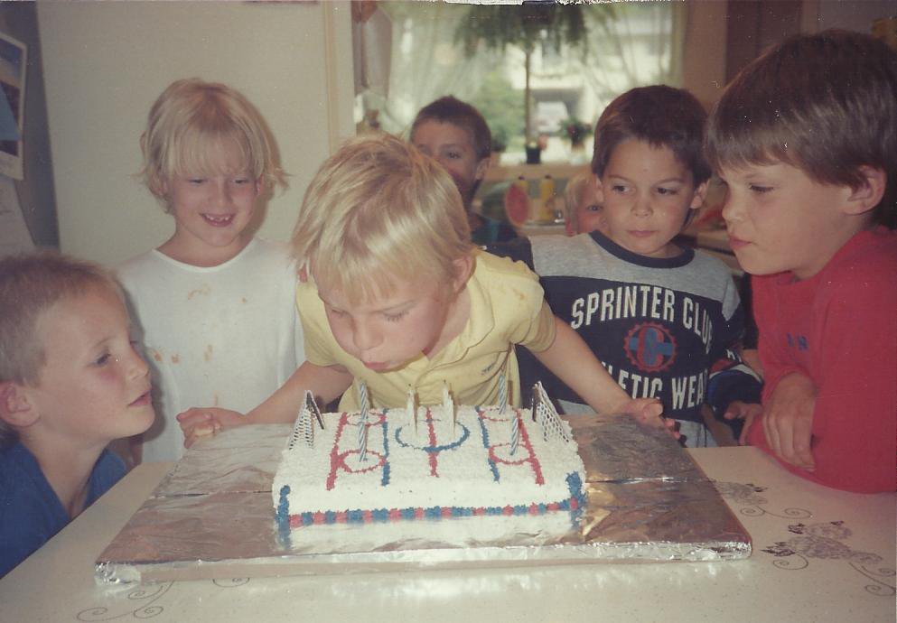 Blowing out candles on a hockey rink birthday cake, circa 1990.